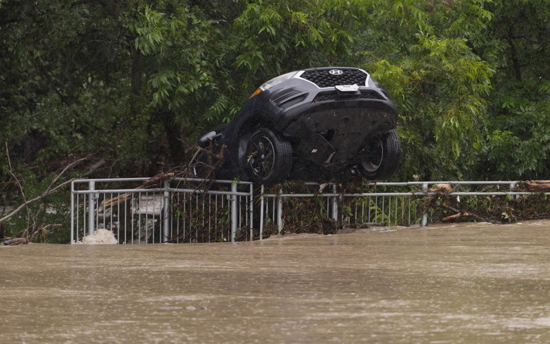 Texas flooding surges from huge rainstorms as rescuers pull people from rising waters