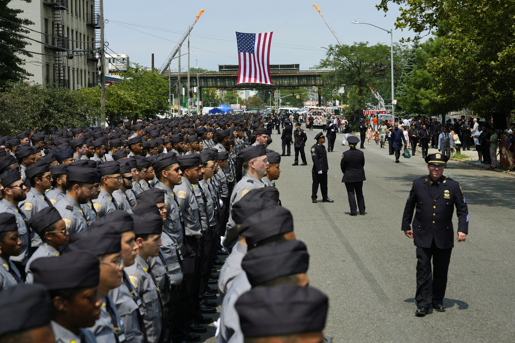 Mourners honor the NYPD officer killed in Monday's attack at NFL office