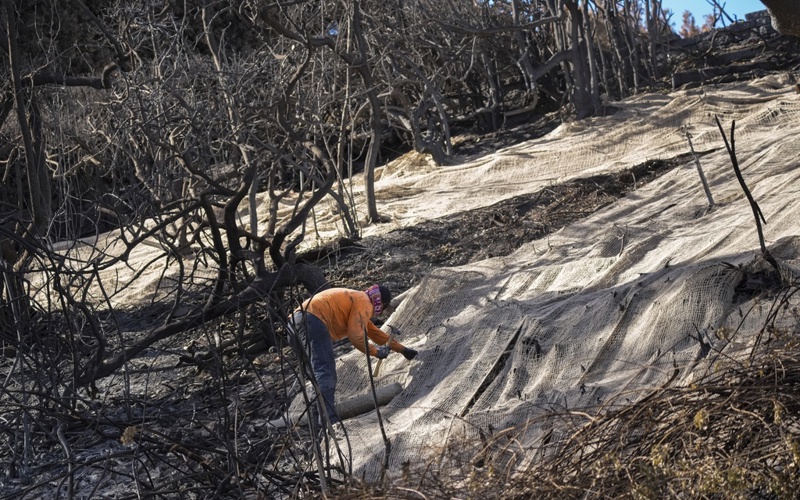 Rain helps Southern California firefighters but sends ash and mud flowing down hillsides