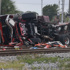 15 hurt when passenger train strikes fire truck that drove into crossing after freight train passed